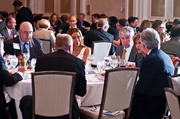 Attendees gather for a collaborative roundtable discussion during the Senior Government Executive Dinner in July.
